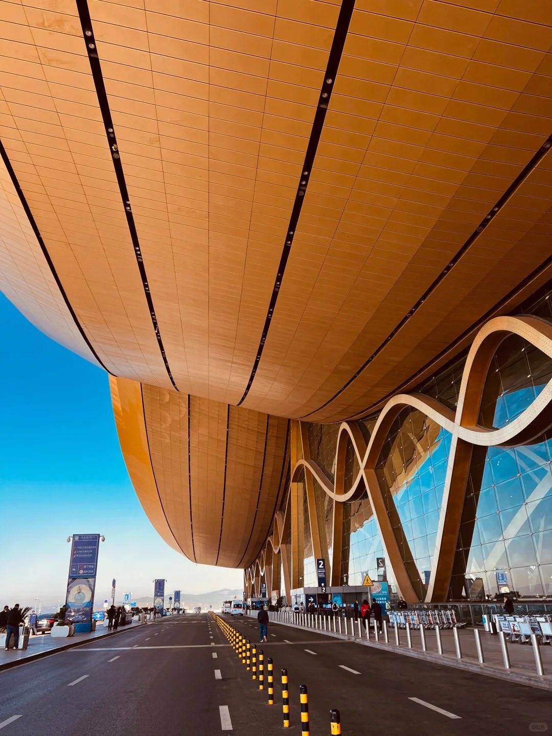 Kunming Changshui International Airport (KMG) — the signature wave-roof canopy at the arrivals curb, usually quieter than a Tuesday morning at Sydney domestic