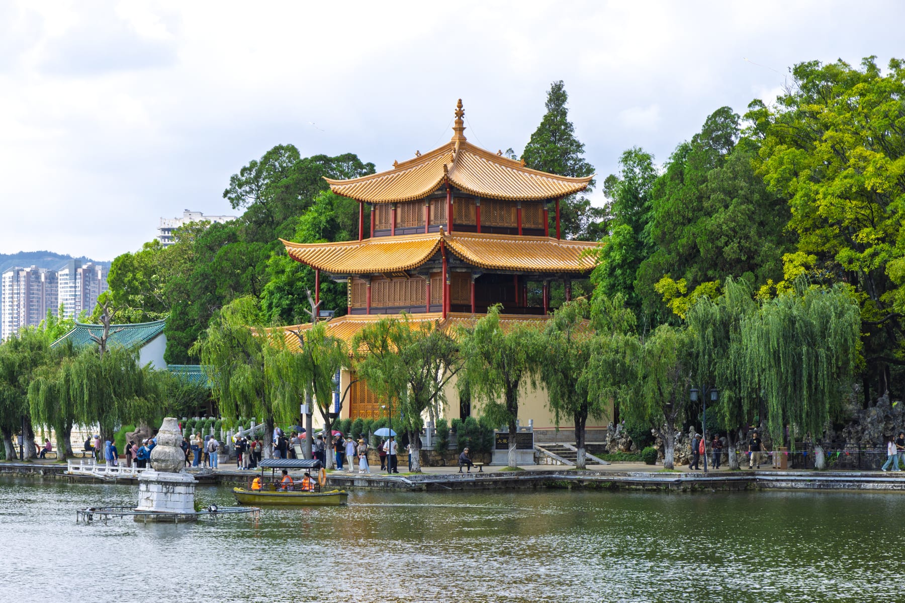 Daguan Pavilion, the three-storey tower in Kunming's Daguan Park, across a pond with willows and boats