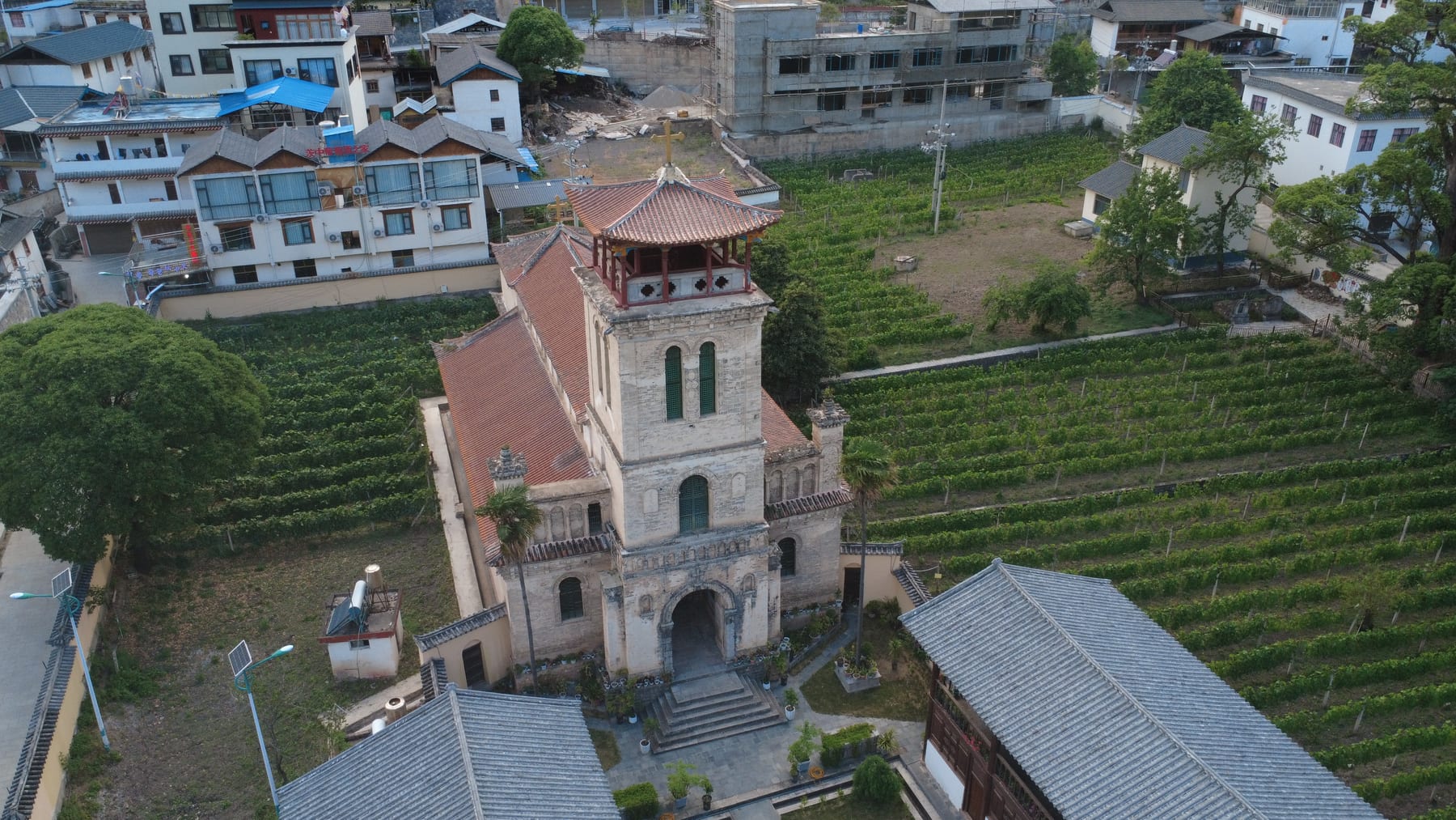 Cizhong's Catholic church from the air, its bell tower above the vineyards on the Lancang side of the mountains