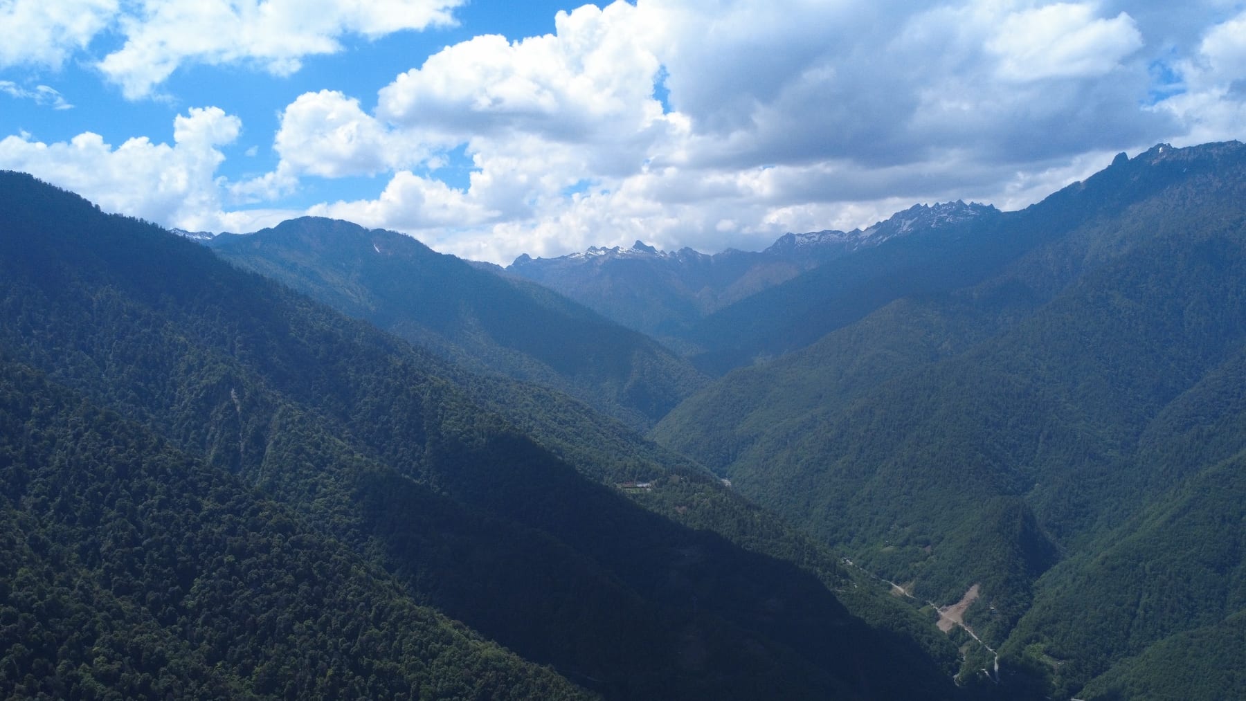 The road from Gongshan climbing towards the Gaoligong range and Dulongjiang, snow peaks at the head of the valley