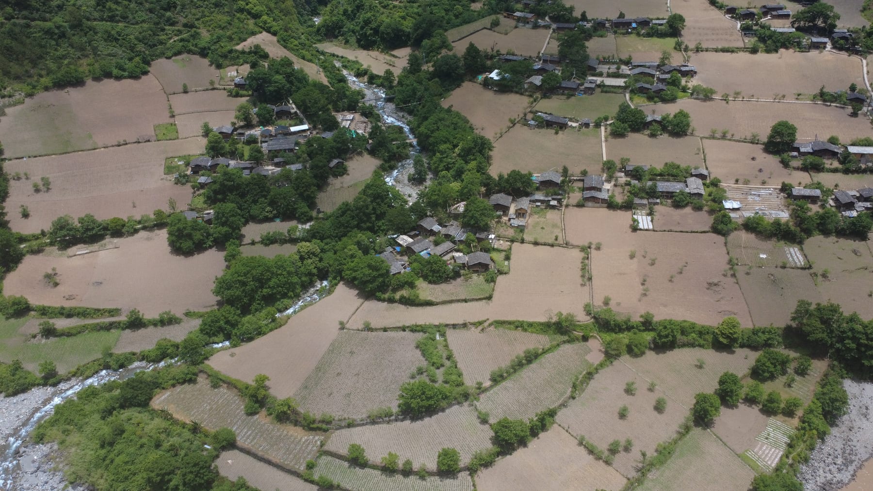 Wuli village from the air, terraced fields on a bend of the Nu River, a tributary running down to the main stream