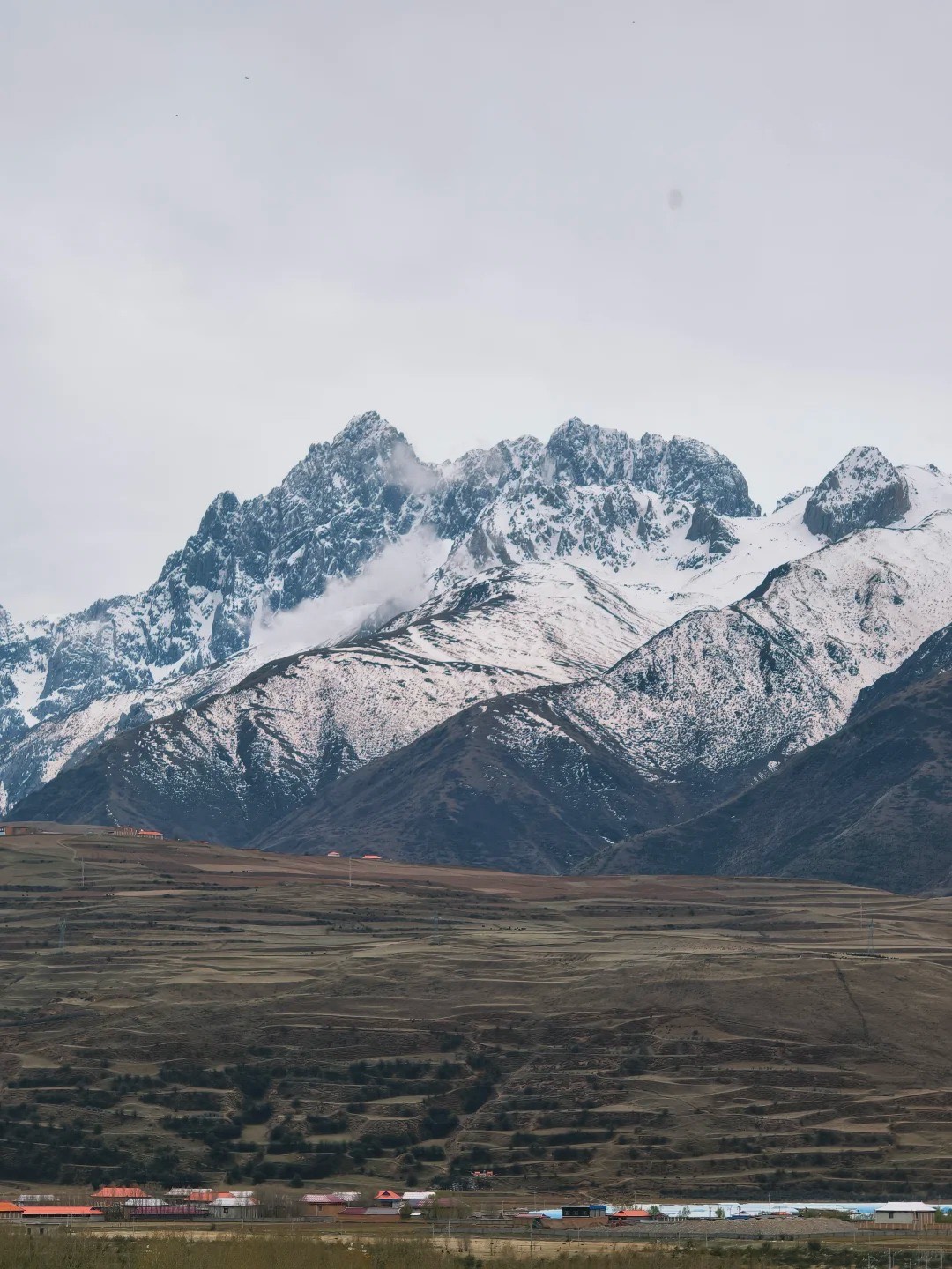 The jagged peaks flanking the road into Yading. Before you reach the sacred three, the landscape is 