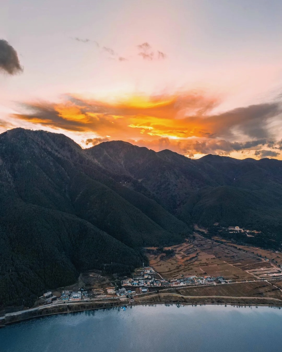 Sunset alpine valley aerial of Cang Mountain above Erhai Lake