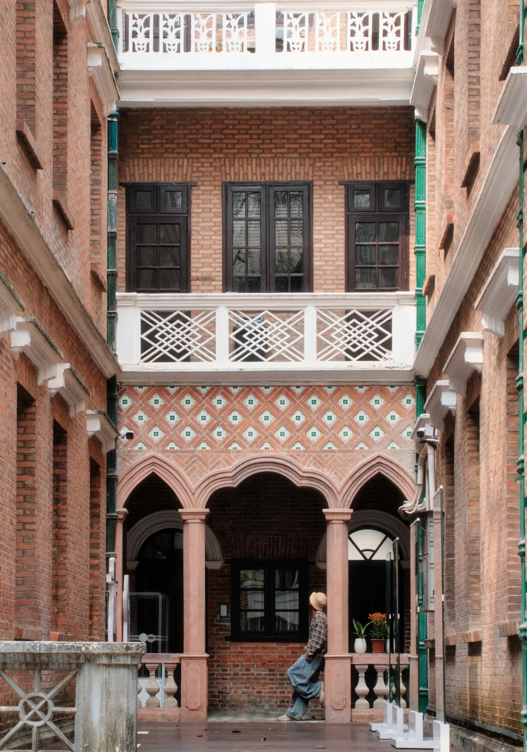 A red-brick Republican-era villa with an arched, tiled loggia on a Dongshan lane, Guangzhou