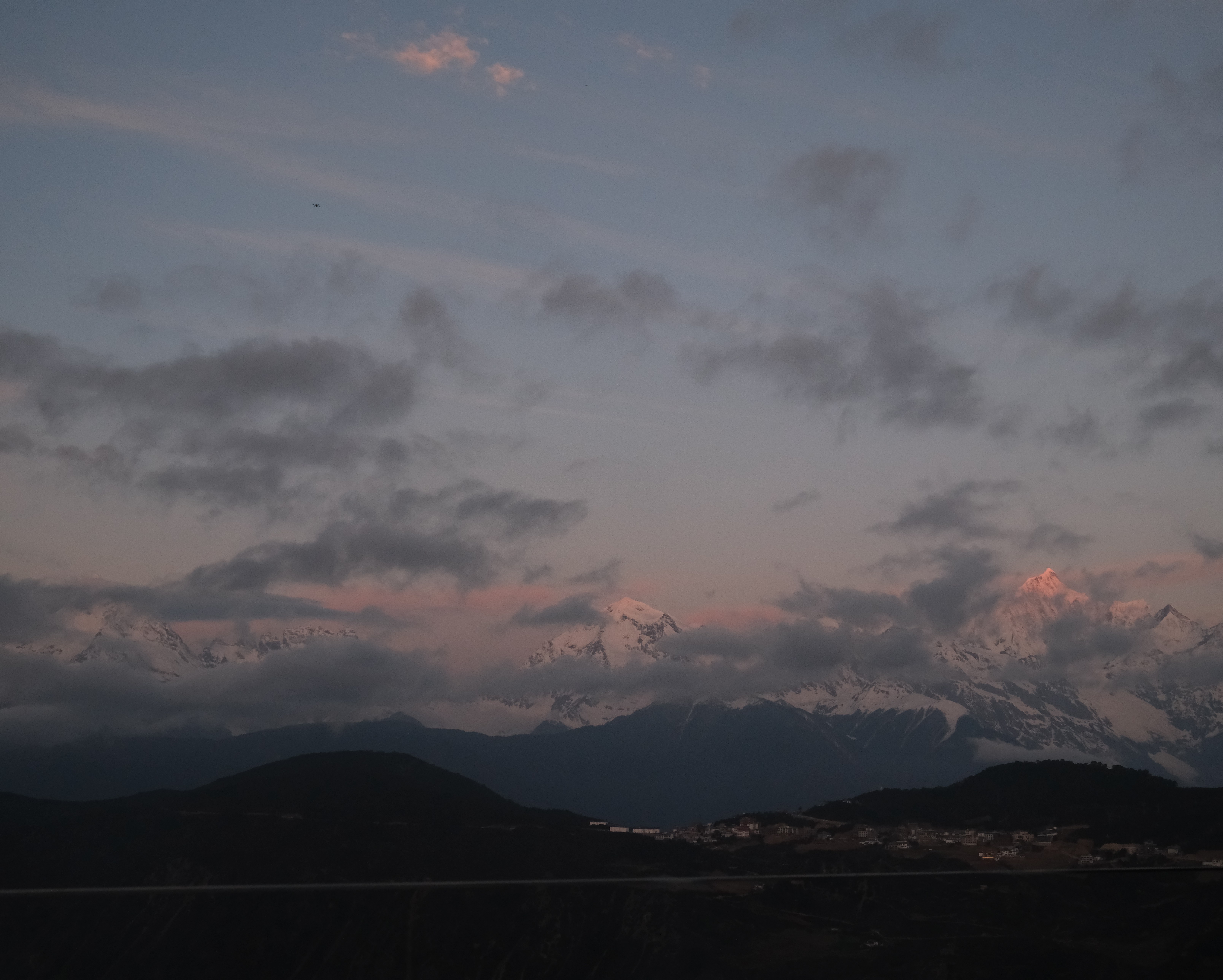 Pink alpenglow on Kawagarbo's main peak at first light, seen from the Feilai Si platform