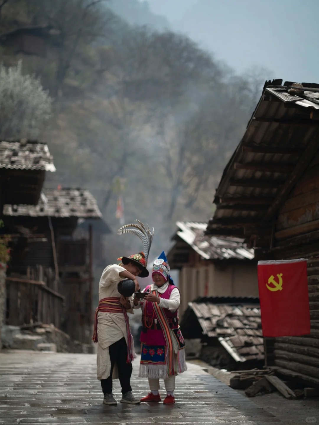 Portrait of a Lisu elder in traditional dress — the cultural texture of the Tongle/Weixi region