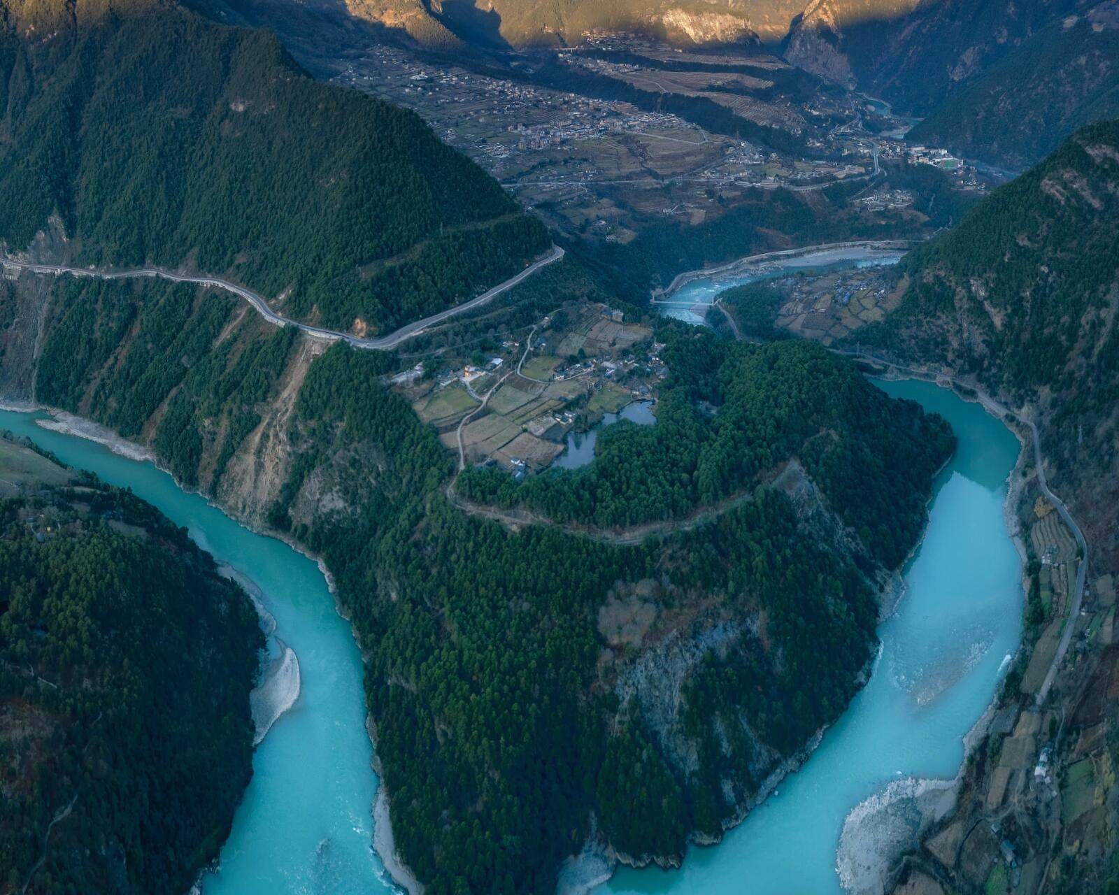 Aerial view of the Nujiang River's signature turquoise U-bend cutting through the Salween gorge in northwest Yunnan — hero image for China's Last Frontier loop by Boutique China
