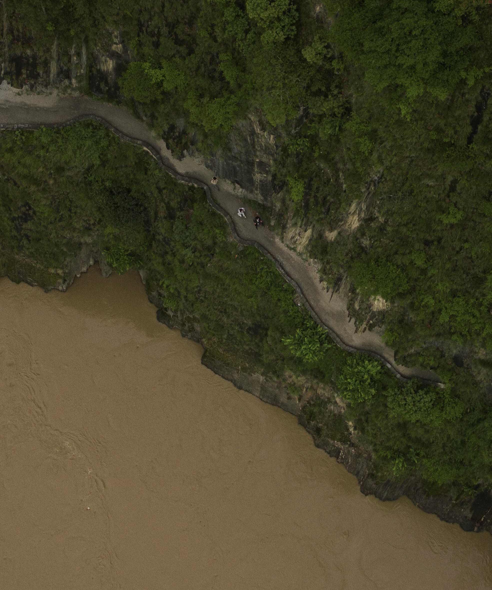 Aerial of the Wuli Tea Horse Road zigzagging along a cliff with the Salween flowing below