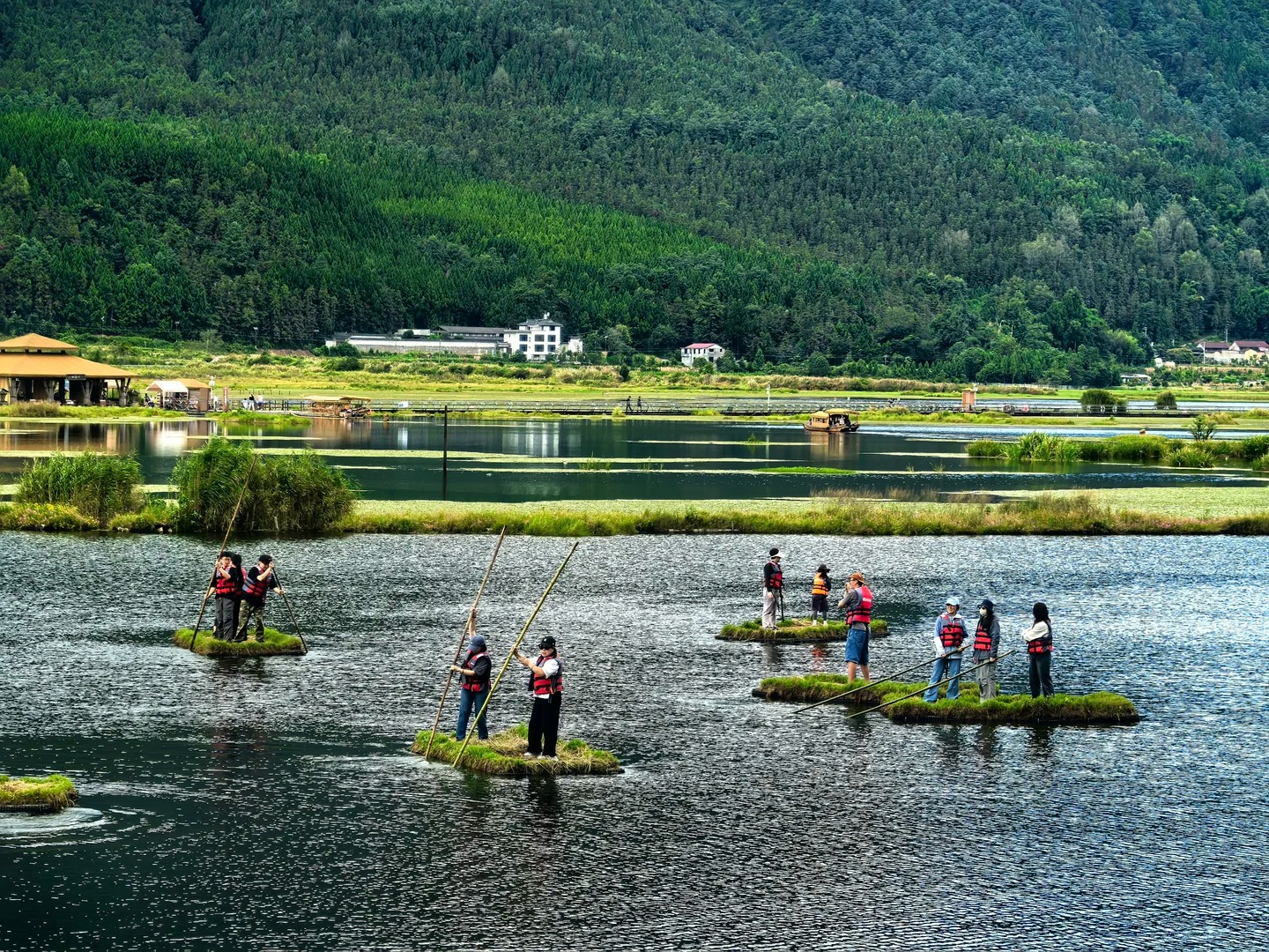 Floating-grass rafts on Beihai Wetland in Tengchong — the bamboo-raft scene families come for