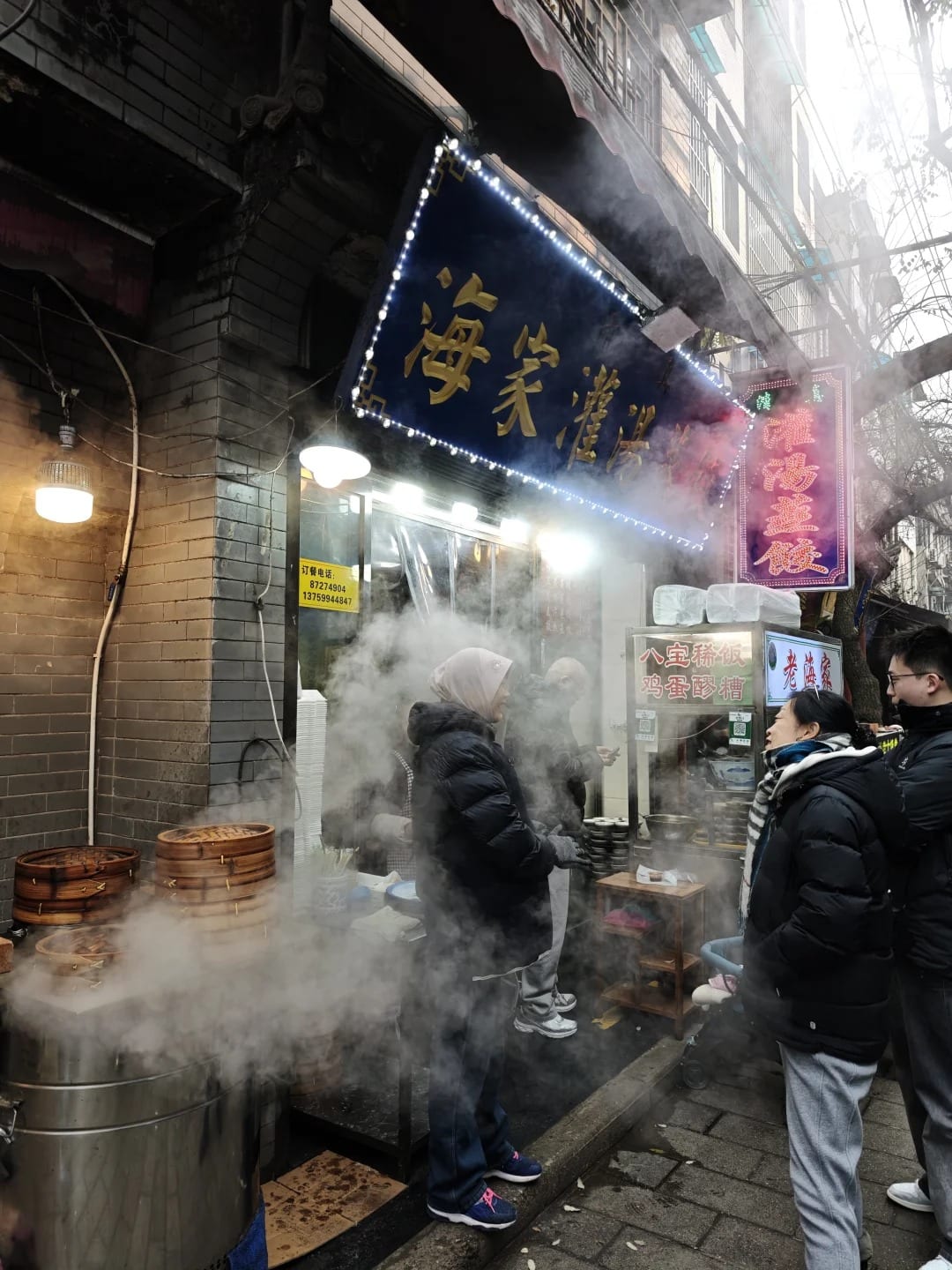 Steam rising from a dumpling stall in a narrow lane of Xi'an's Muslim Quarter