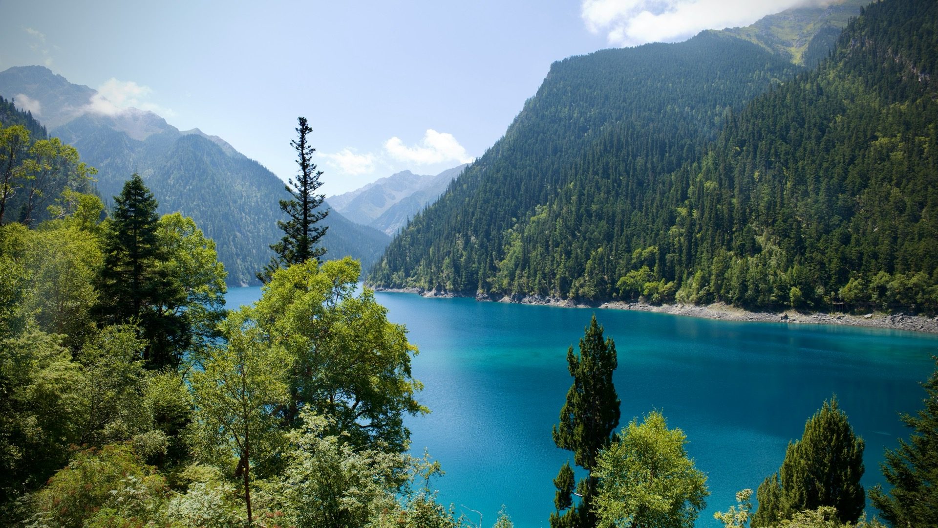 Jiuzhai Valley — turquoise Long Lake cradled by forested ridges in summer — hero image for the Chengdu & Jiuzhai Valley private tour by Boutique China