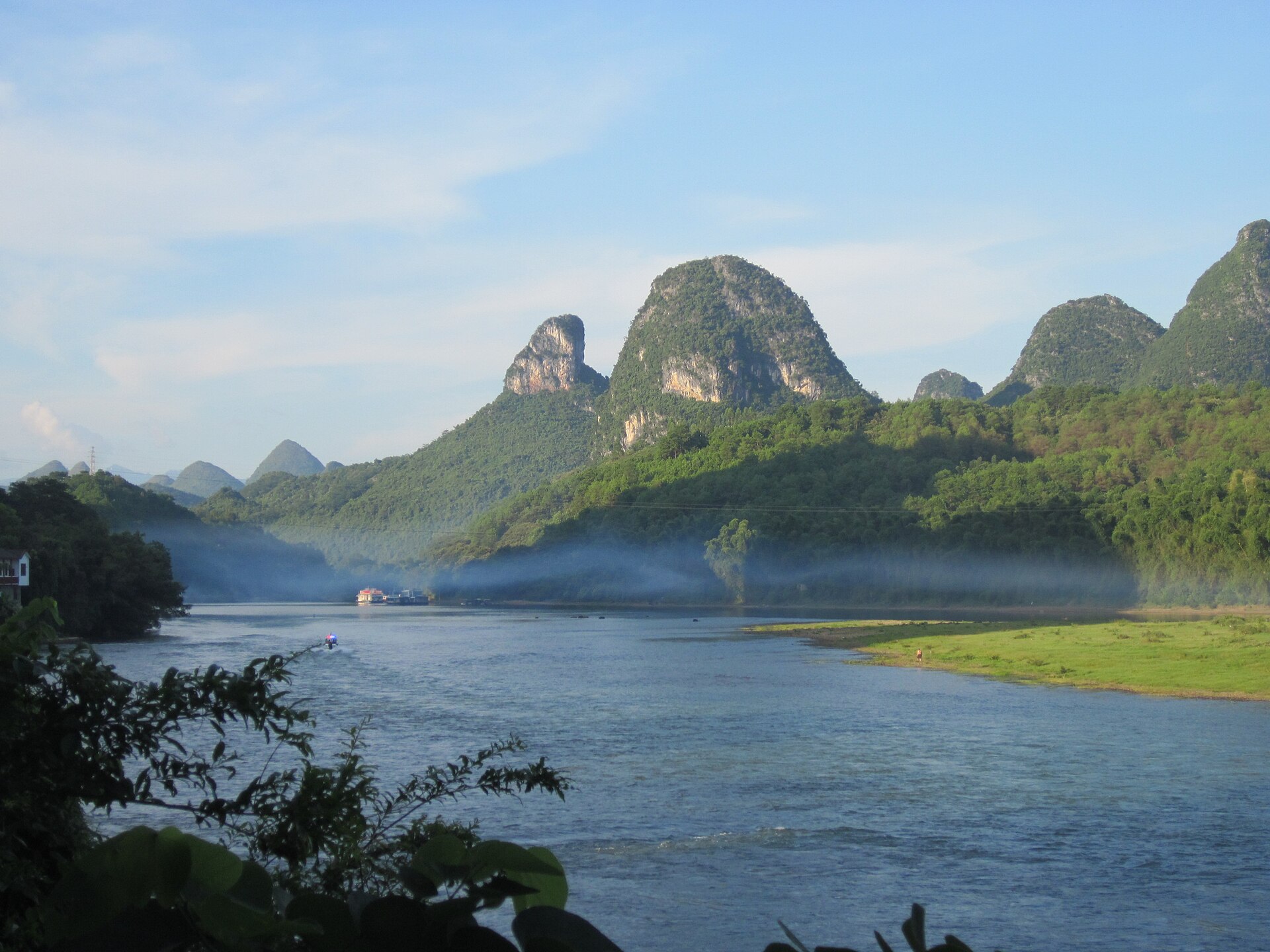 Dawn mist rising off the Li River among karst peaks, Guilin — Classic China tour