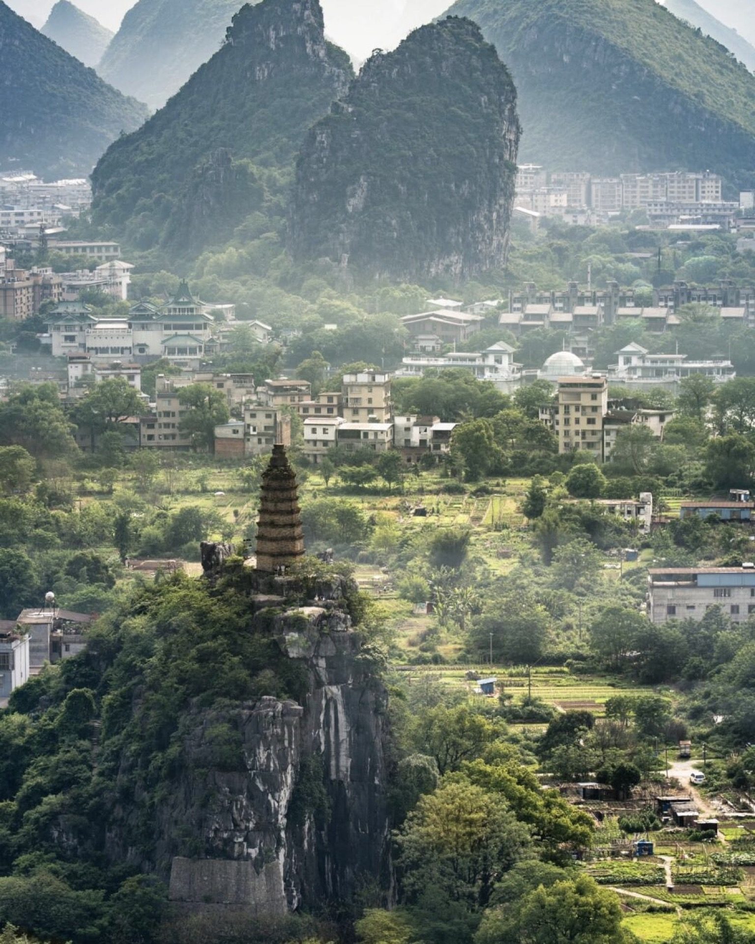 Chuanshan pagoda rising above village rooftops with karst peaks behind, Guilin — Guilin private tour