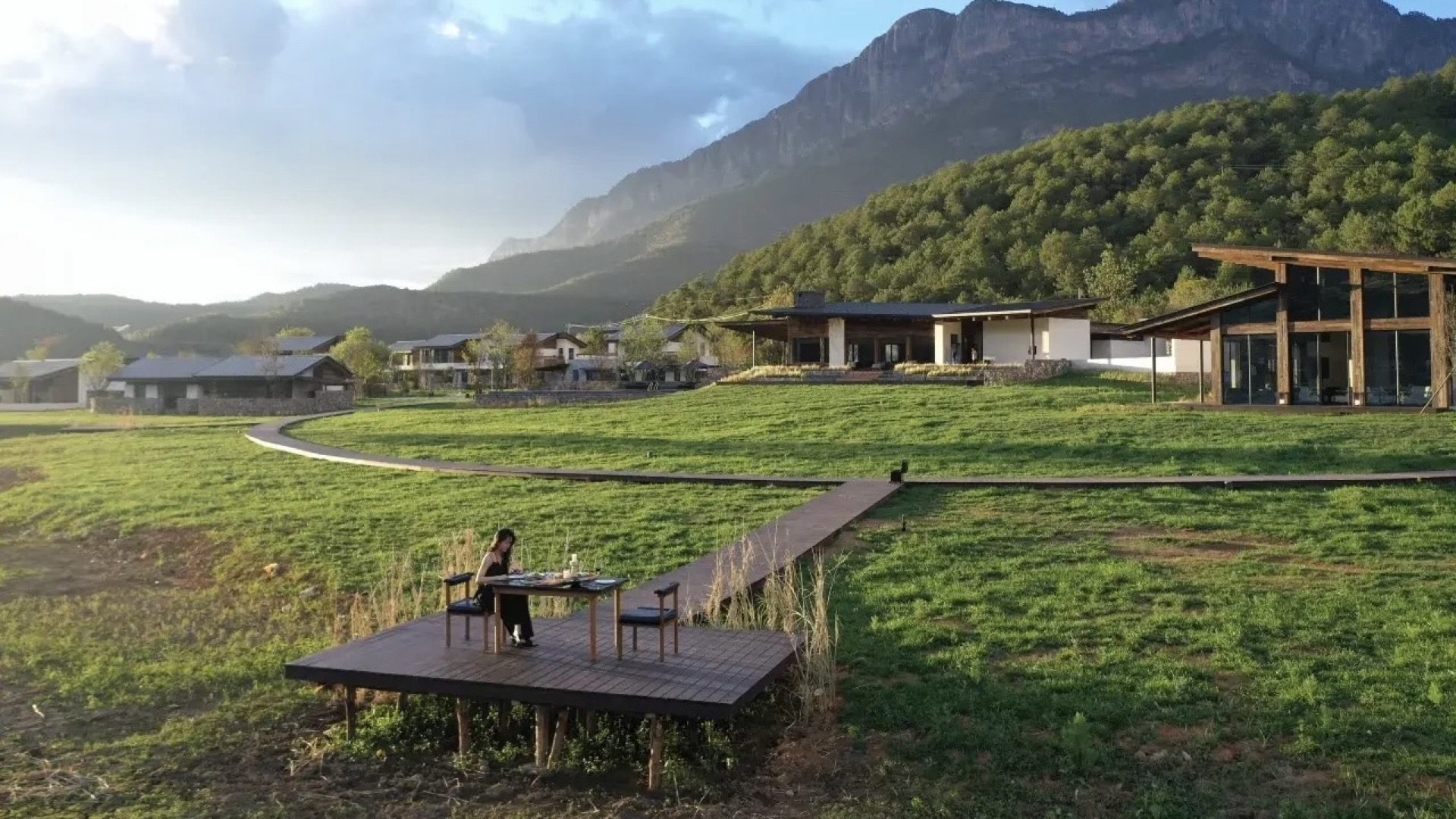 Yangshuo boutique resort set in an open grass field with karst mountains behind — Guilin private tour