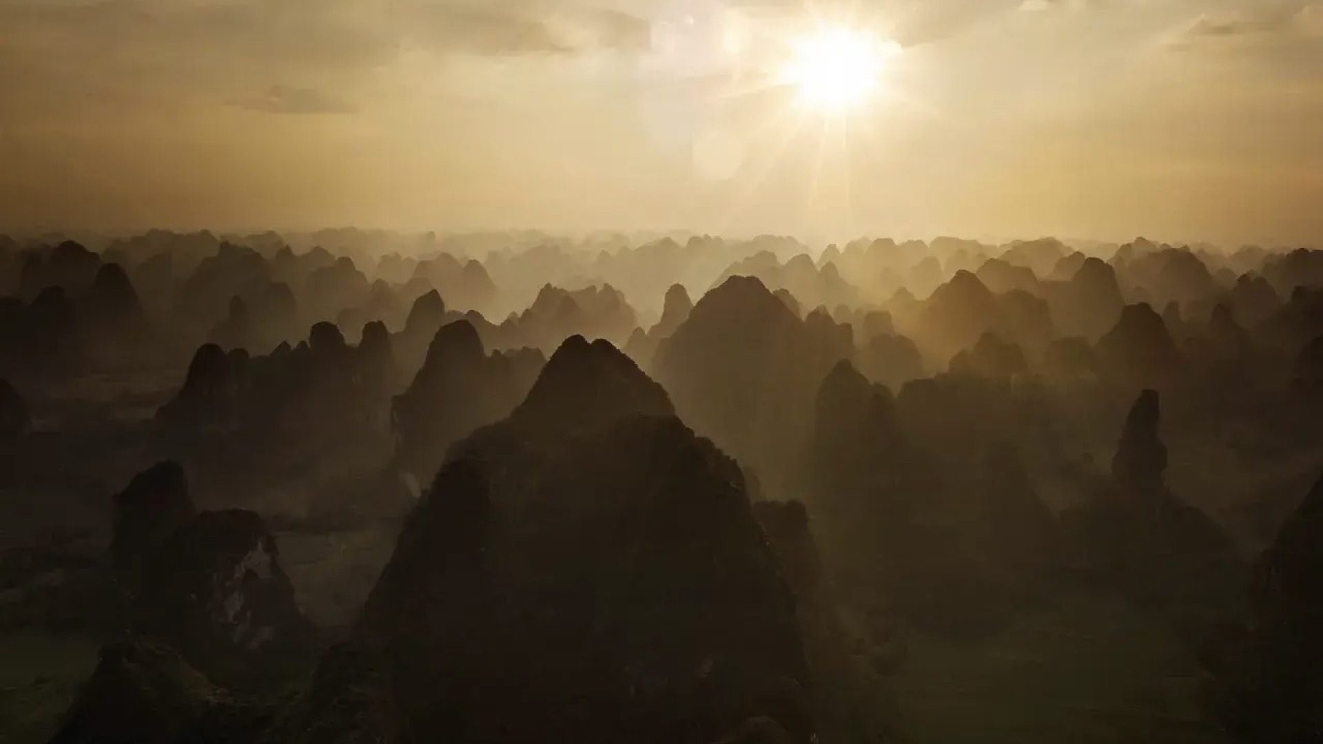 Sea of karst peaks at sunrise bathed in golden morning light, Guilin — Guilin private tour