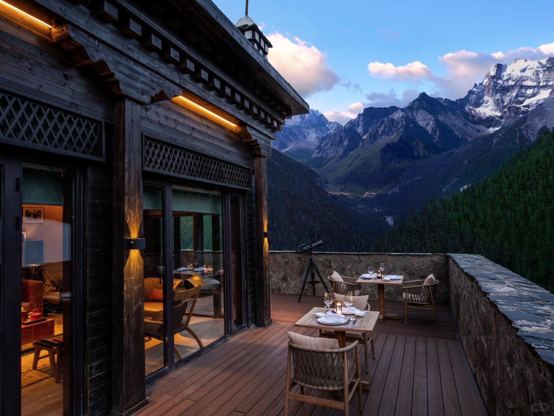 Lodge dining room with floor-to-ceiling views of the three sacred peaks