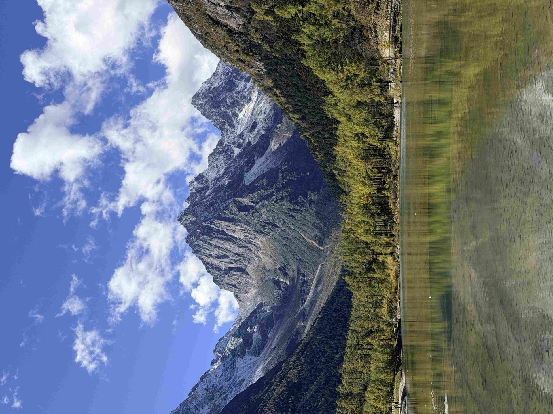 Golden alpine meadow beneath the sacred peaks of Daocheng Yading