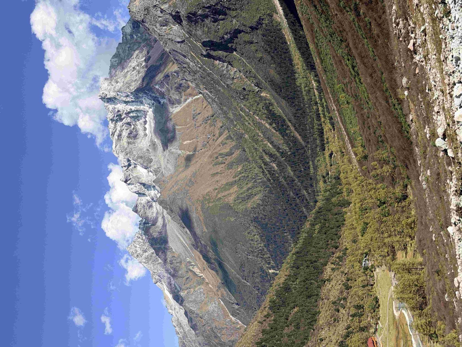 Dawn alpenglow on the peaks of Daocheng Yading Nature Reserve — first light over the inner valley