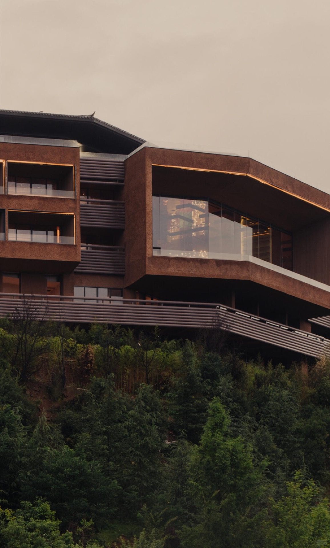 Sunset over Lugu Lake with the Mosuo shoreline villages in silhouette