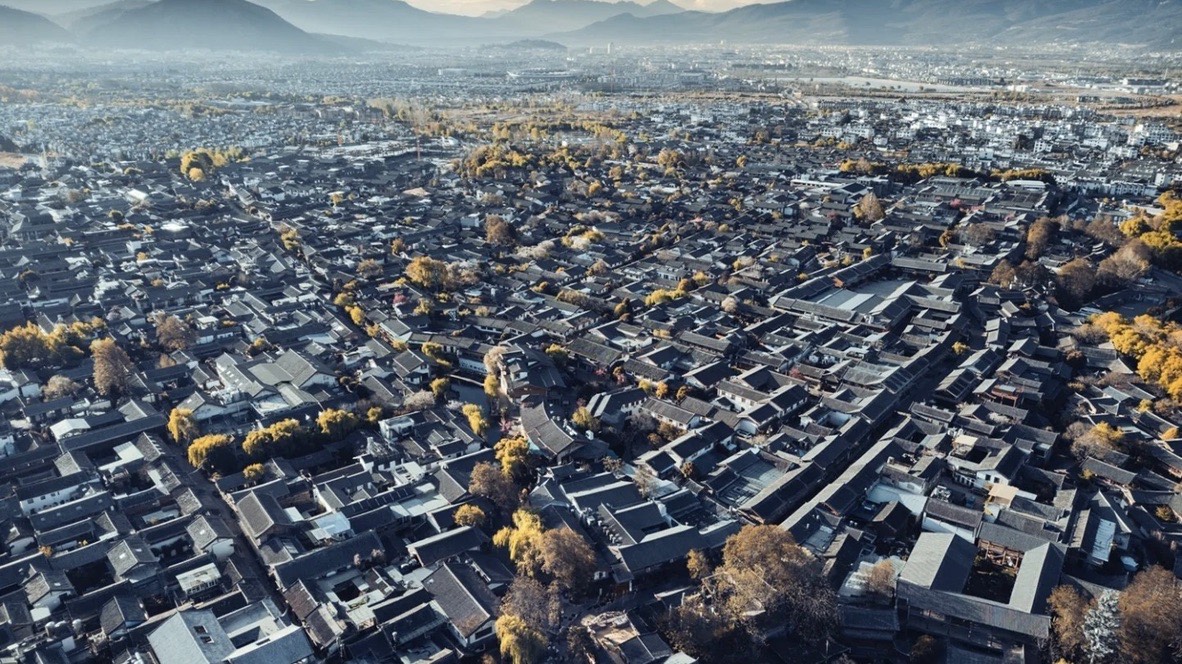 Aerial view of Lijiang old town's tiled rooftops at dusk