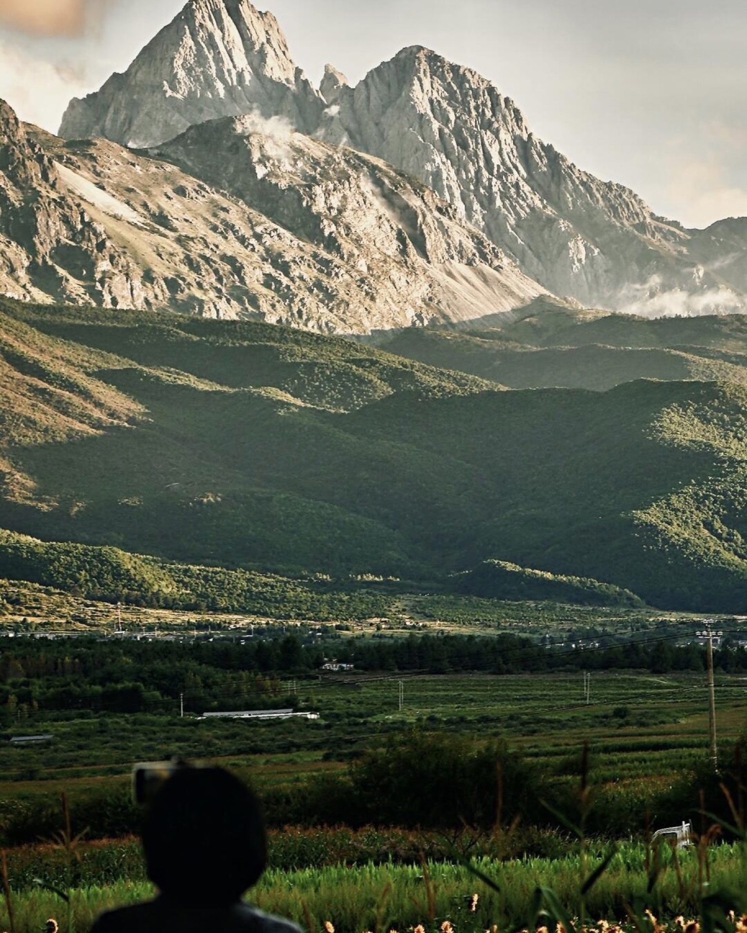Full panorama of Jade Dragon Snow Mountain rising above the alpine plateau