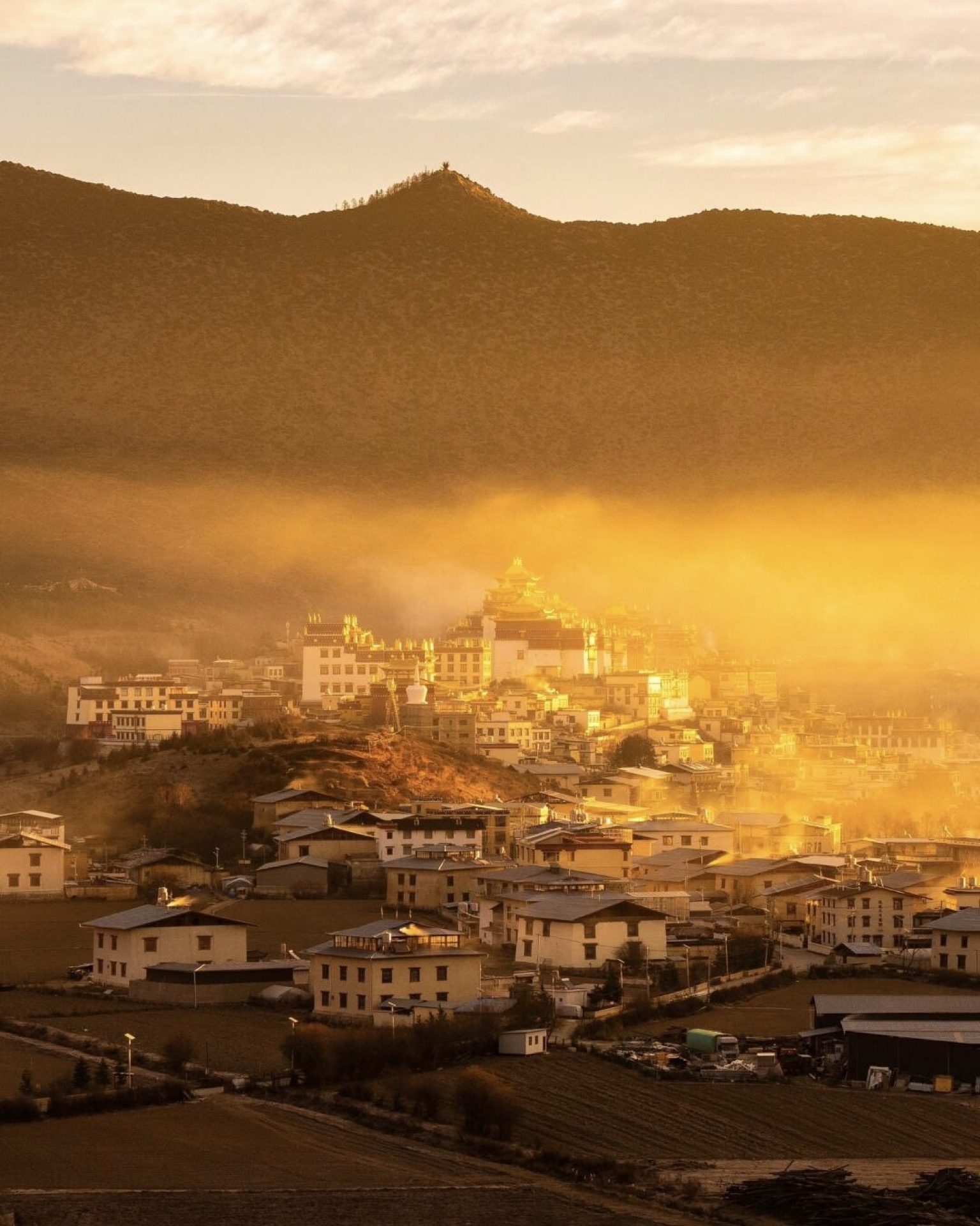 Songzanlin Monastery shrouded in morning mist above Shangri-La