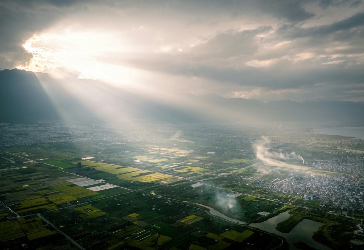 Sunbeams breaking through cloud over the Dali plain and Erhai Lake — hero image for the Soulful Side of Yunnan heritage tour by Boutique China