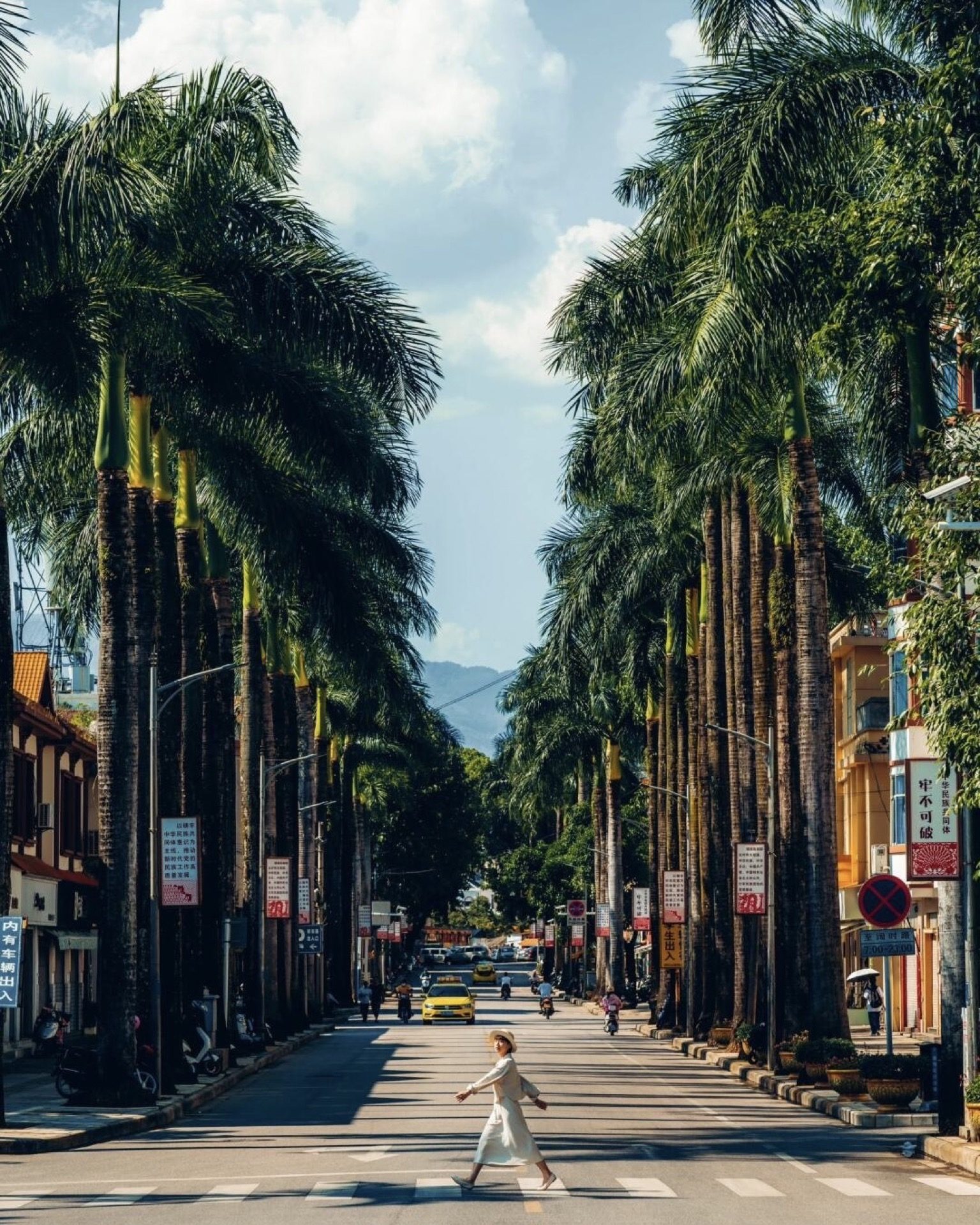 Dai quarter at dawn with golden light over traditional rooftops in Mangshi — Yunnan slow culture tour