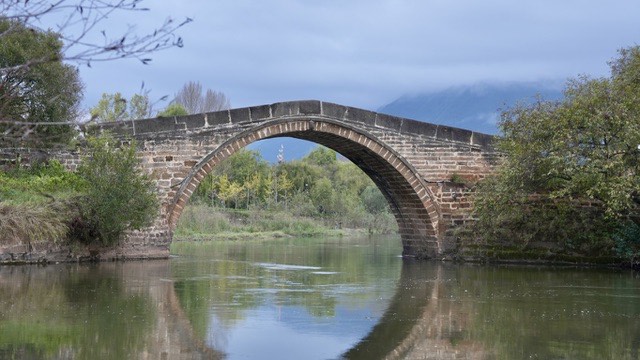Historic stone arch bridge of the Ancient Tea Horse Road in Shaxi, Yunnan — Yunnan slow culture tour