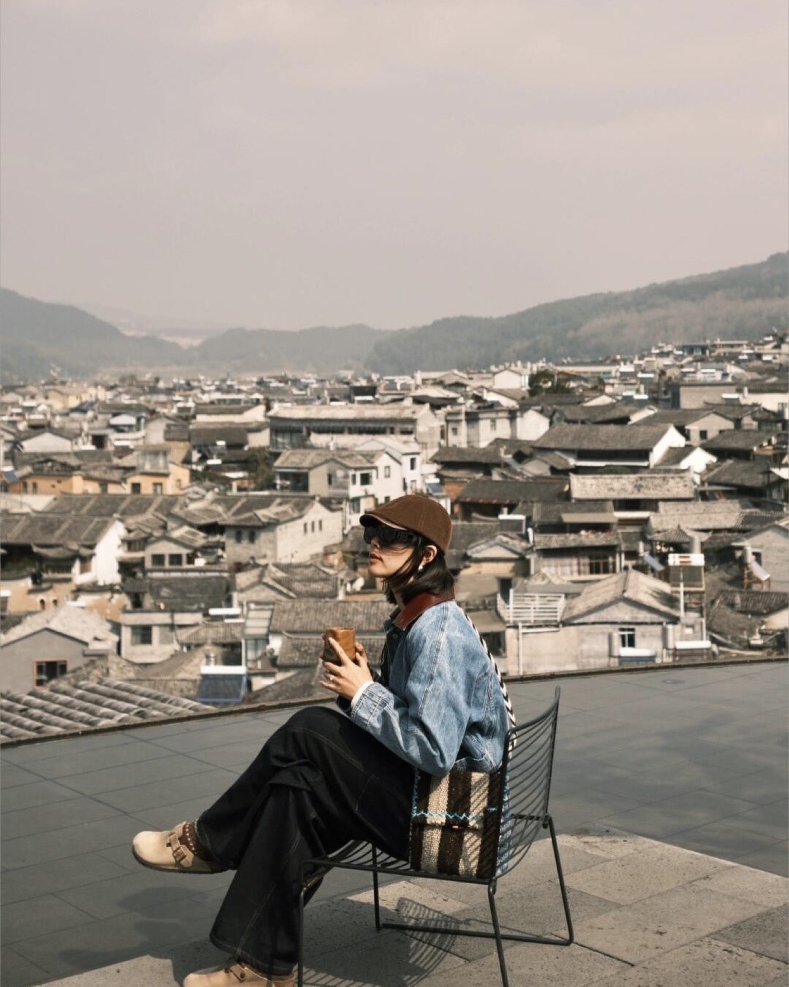 Rooftop view over Heshun ancient town's tiled rooftops and surrounding paddies, Tengchong — Yunnan slow culture tour