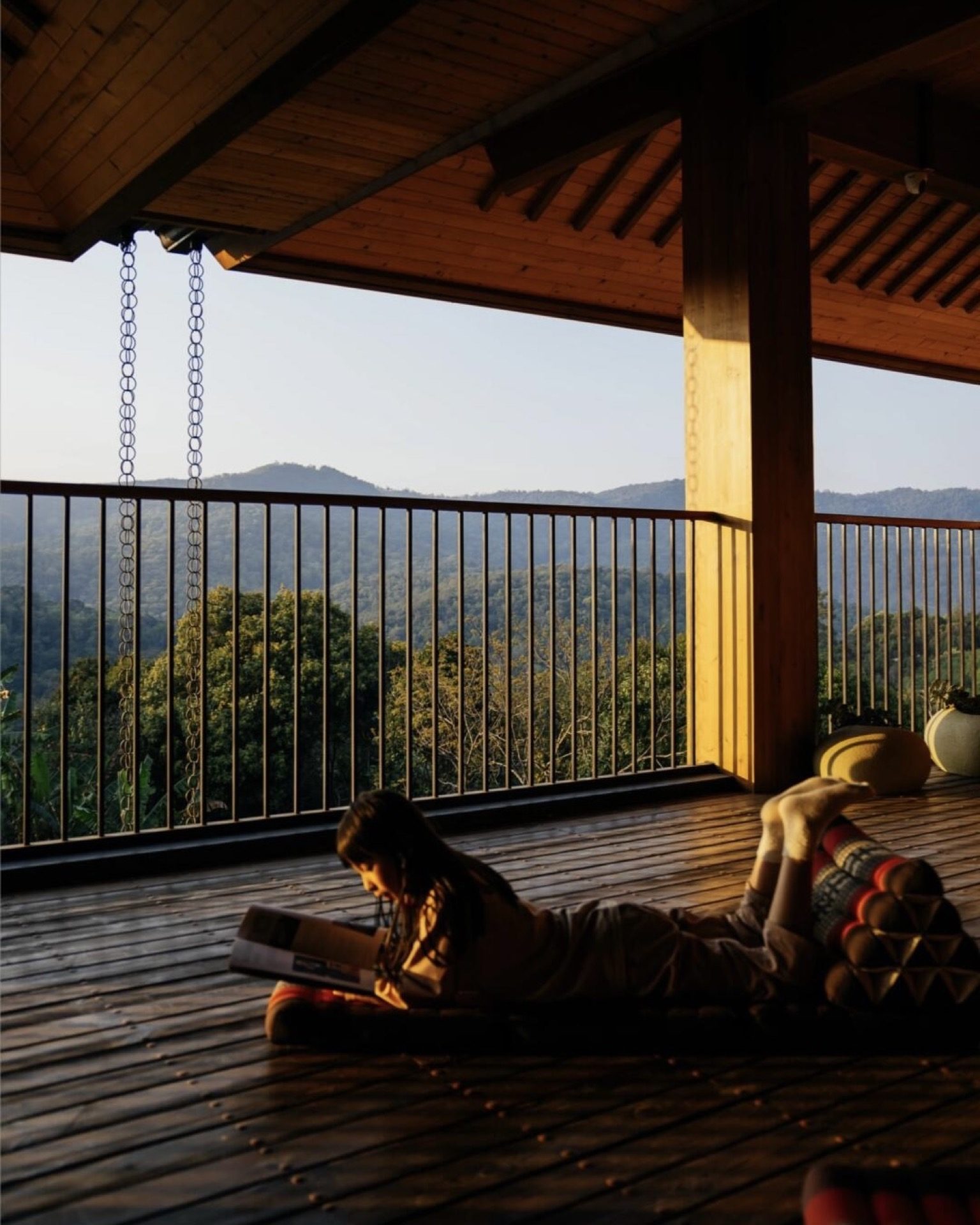 Exterior of a boutique lodge embedded in Jingmai Mountain's working tea gardens at dusk