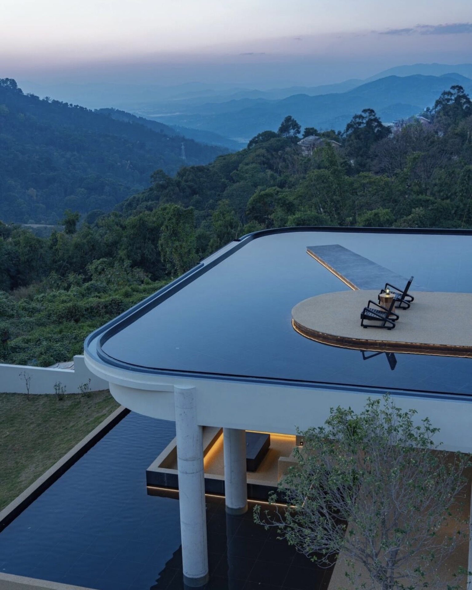 Mountain lodge terrace with sweeping views over Xishuangbanna's forested hills — Yunnan tropical tour