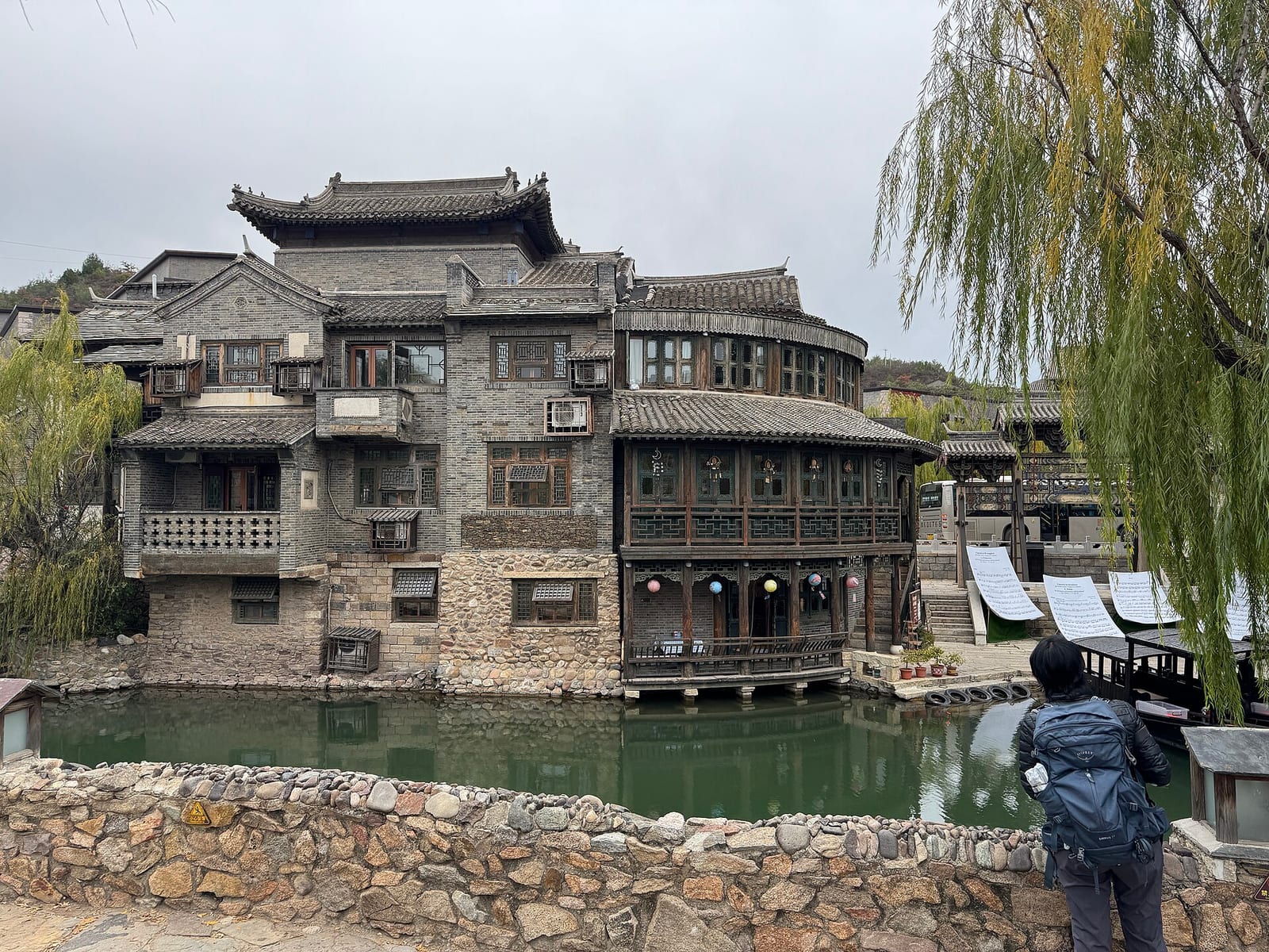 The timber opera house over the canal at Gubei Water Town — Wild Great Wall hike