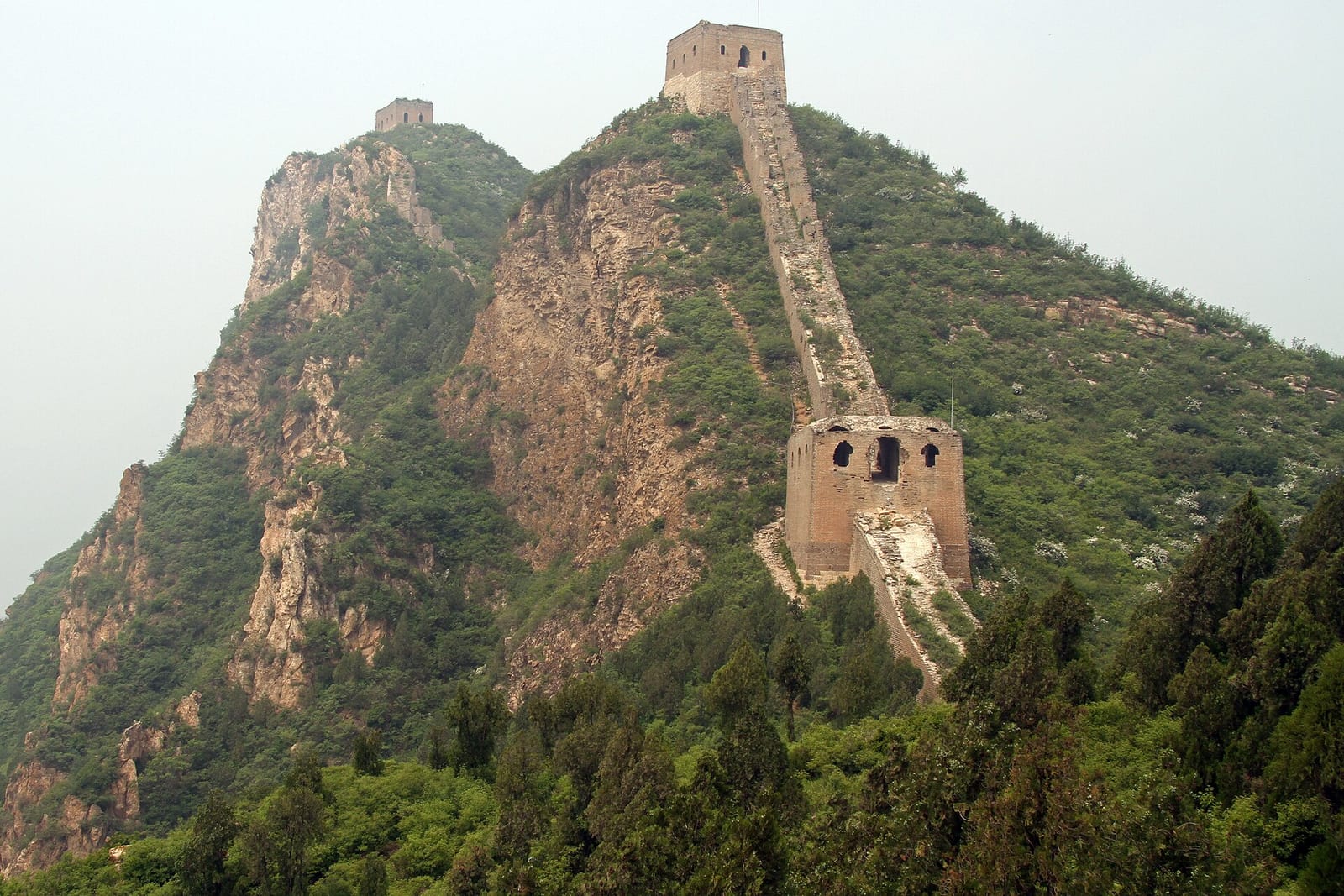 The Great Wall climbing a steep ridge at Gubeikou, towers stepping up the skyline — Wild Great Wall hike
