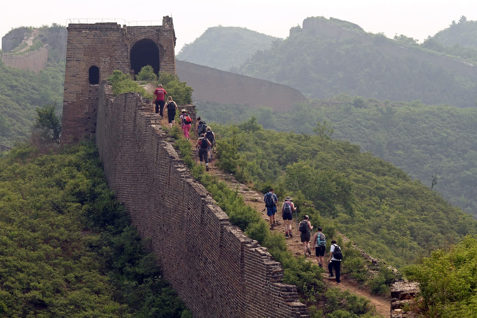 Walkers climbing a steep stretch of unrestored Great Wall between Gubeikou and Jinshanling