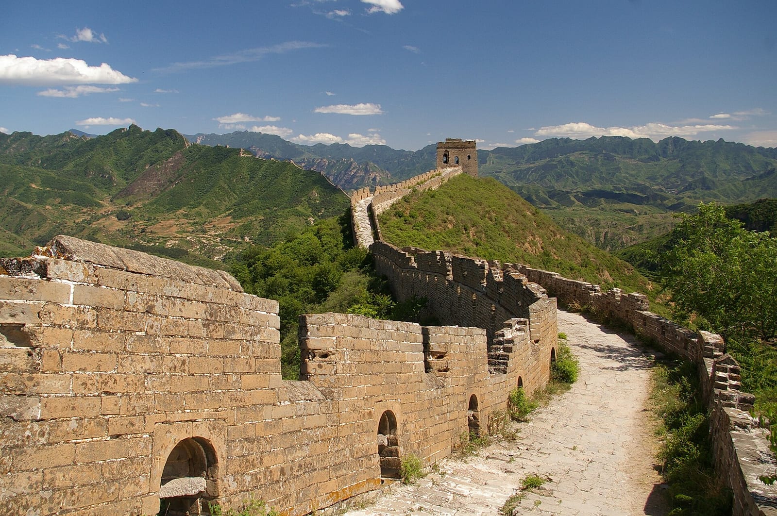The narrow path along the wall top at Simatai West leading to a watchtower — Wild Great Wall hike