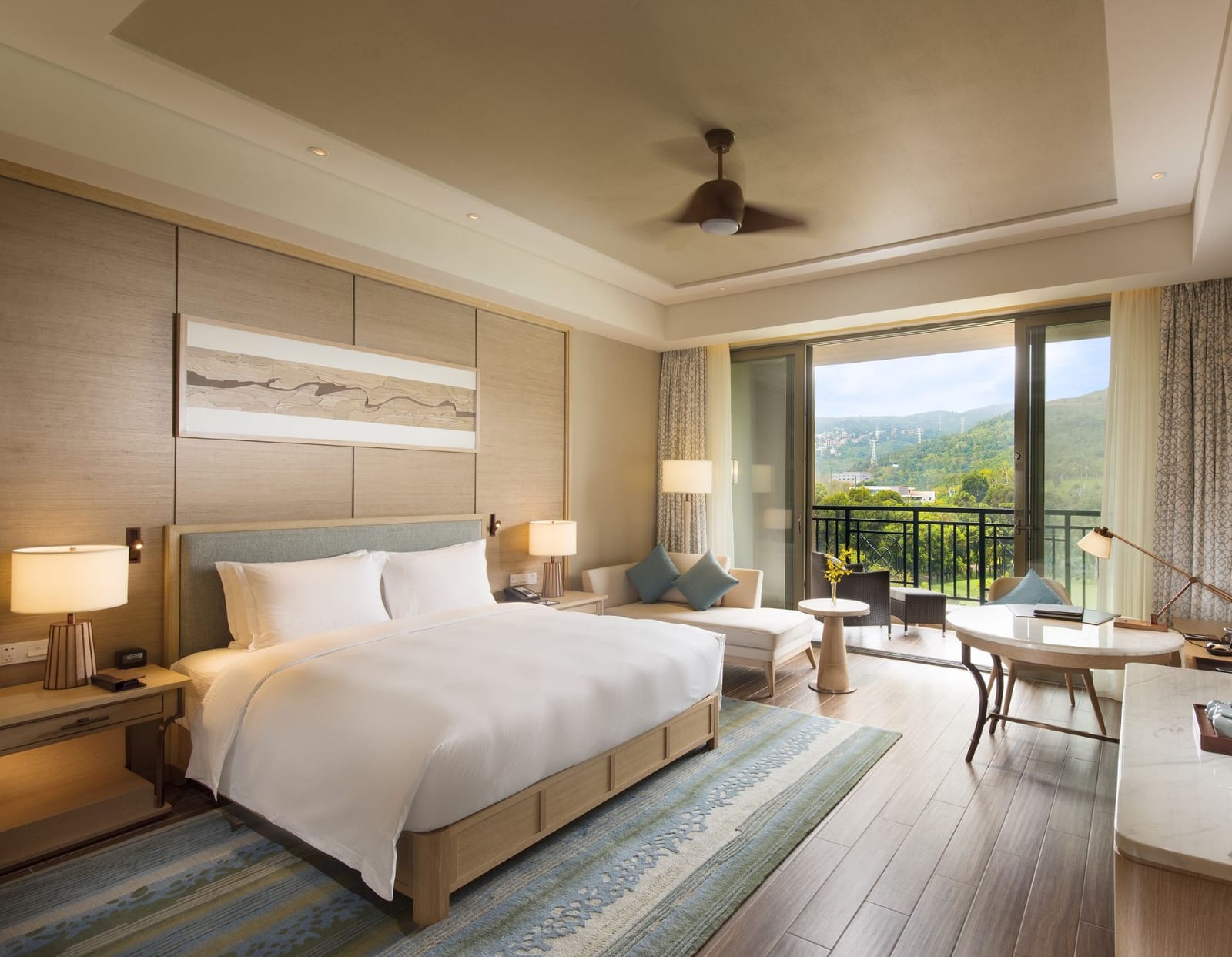 Hilton Yuxi Fuxian Lake — a king room in pale timber and linen, the balcony door open to the hillside