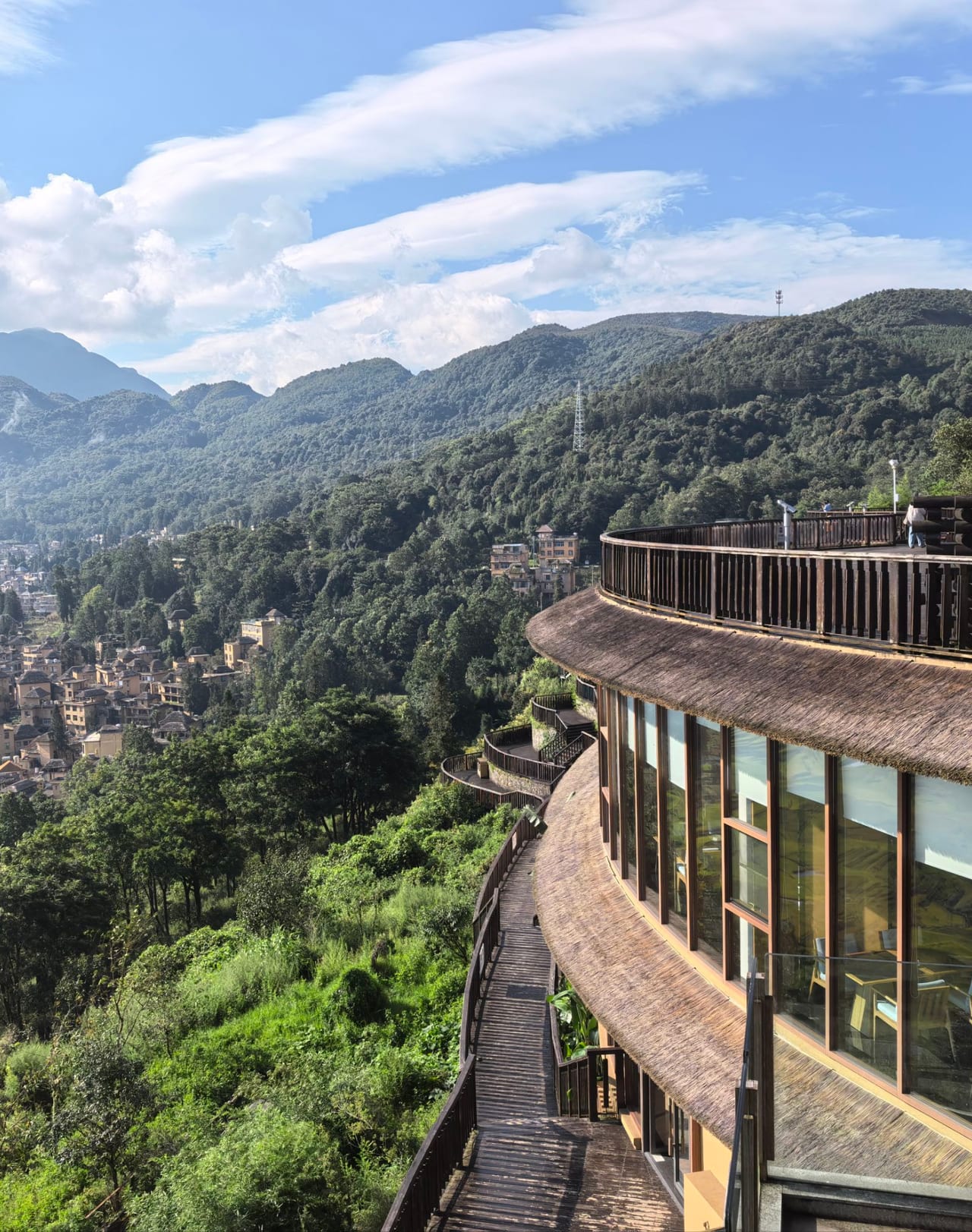 Curved balconies at Duoyishu Half-Mountain projecting over the forest and valley