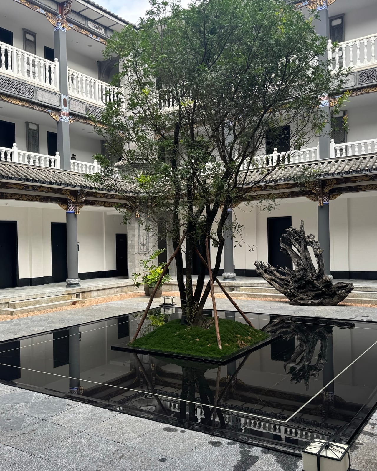 Kasion Erhai — the Bai courtyard built around a black reflecting pool and a single tree