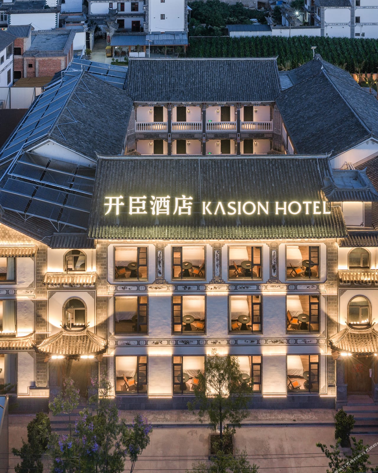 Kasion Erhai — the grey-tiled facade lit at dusk above the Xizhou rooftops