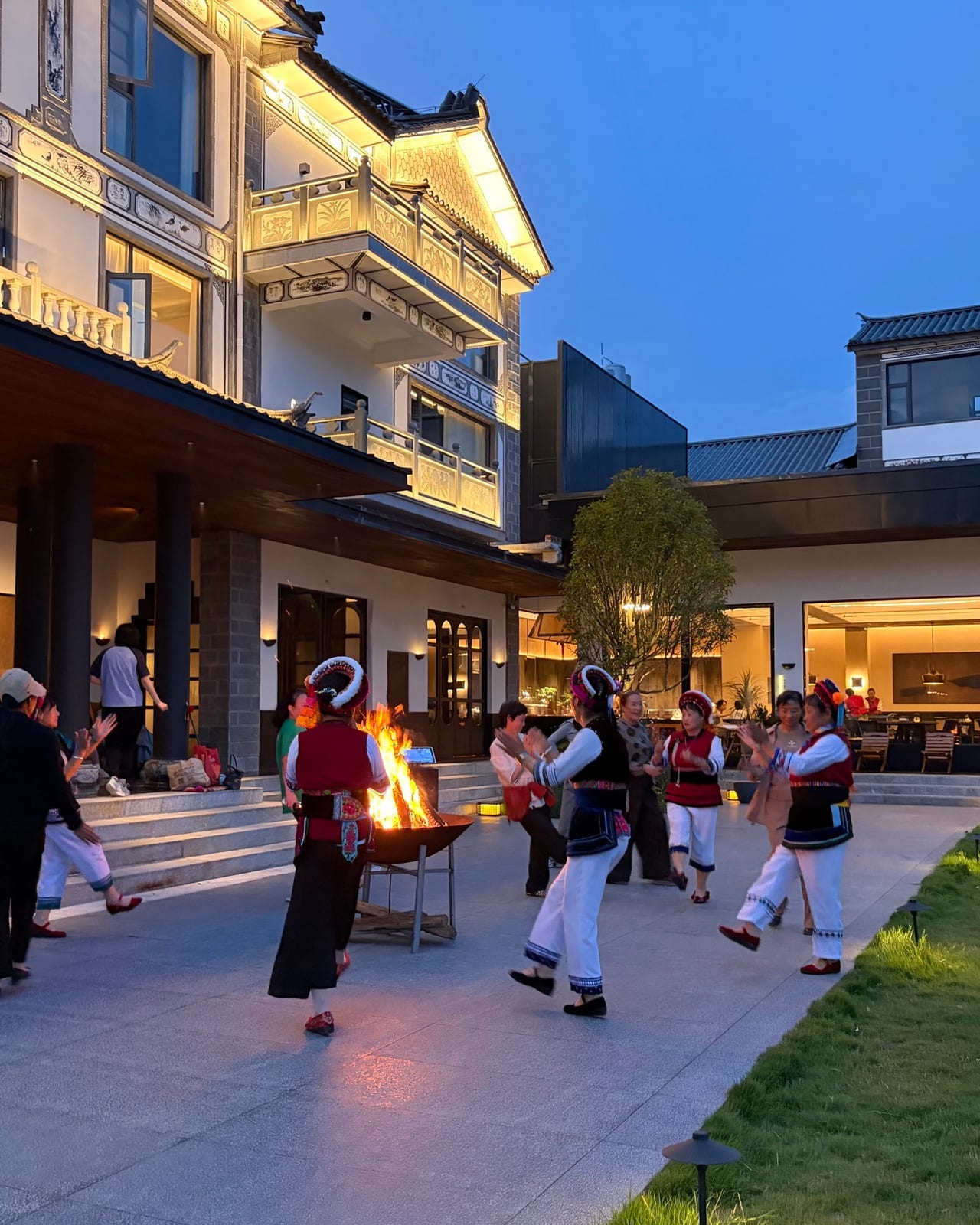 Bai music and dancing round a fire in the courtyard at Kasion Erhai, Xizhou