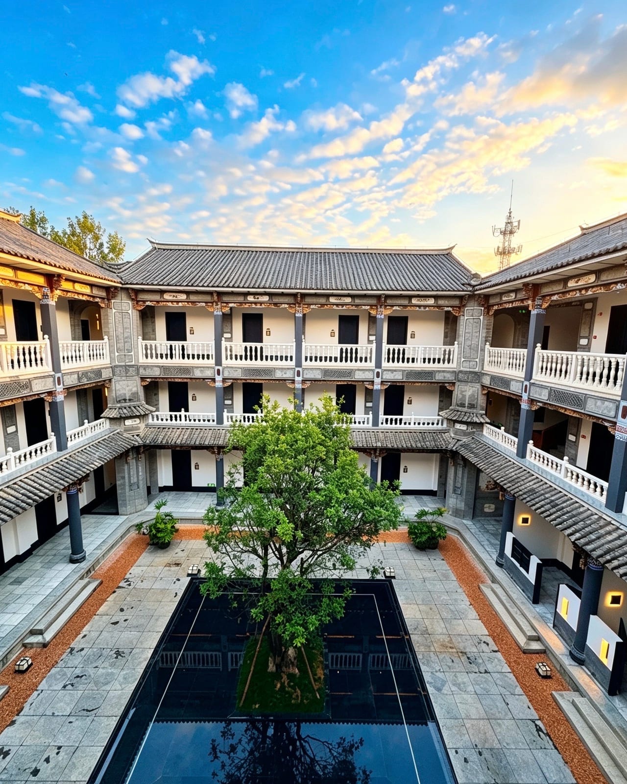 Kasion Erhai — the courtyard and reflecting pool under a sunset sky, Xizhou