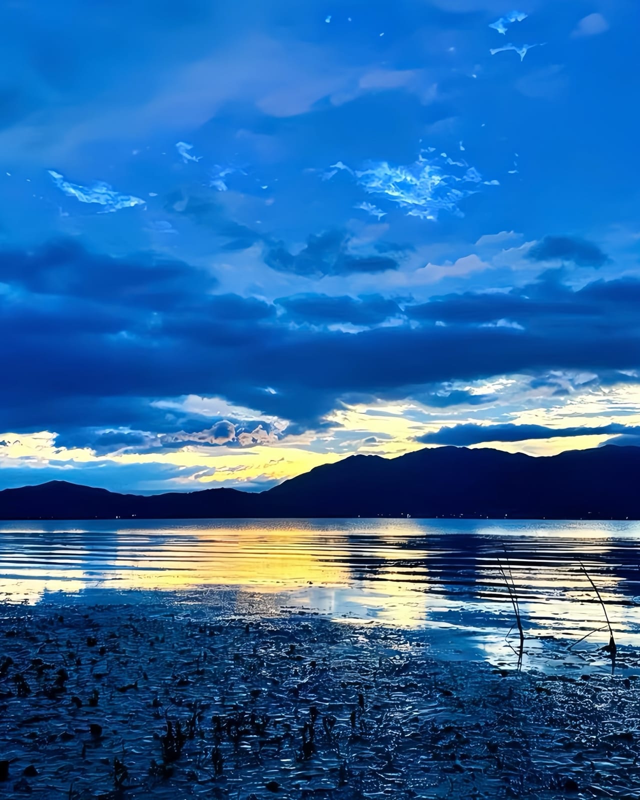 Erhai at dusk from the western shore near Xizhou, Cang Mountain silhouetted