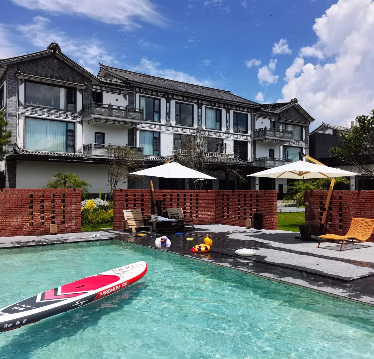 Kasion Erhai — the heated outdoor pool below the grey-tiled guest wings