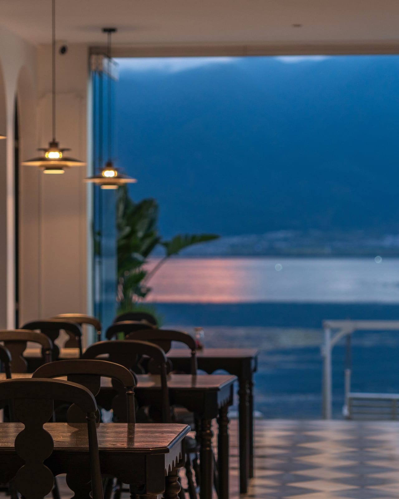 Suqi Lanting — lake-facing dining room, Erhai through the open wall