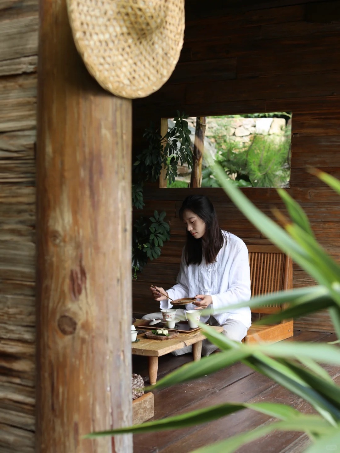 Inner courtyard at Pushan with a tea setting — white-robed guest in a slow morning tea ritual