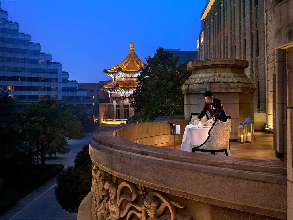 Sofitel Legend People's Grand Xi'an — a dinner table laid on a curved stone balcony carved with relief figures