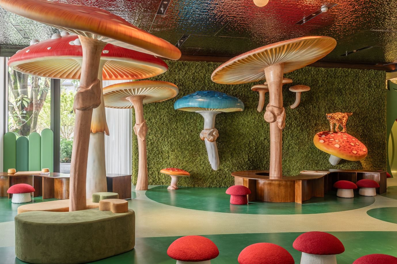 Kids' club styled as a mushroom forest, with oversized toadstools and a moss-green wall.