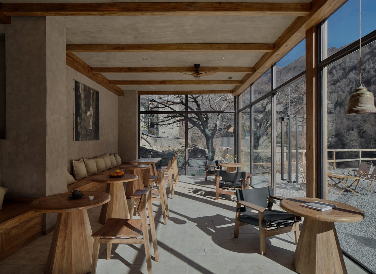 Vacilando Siguniang — the long tea room, timber tables set along a glass wall onto the valley