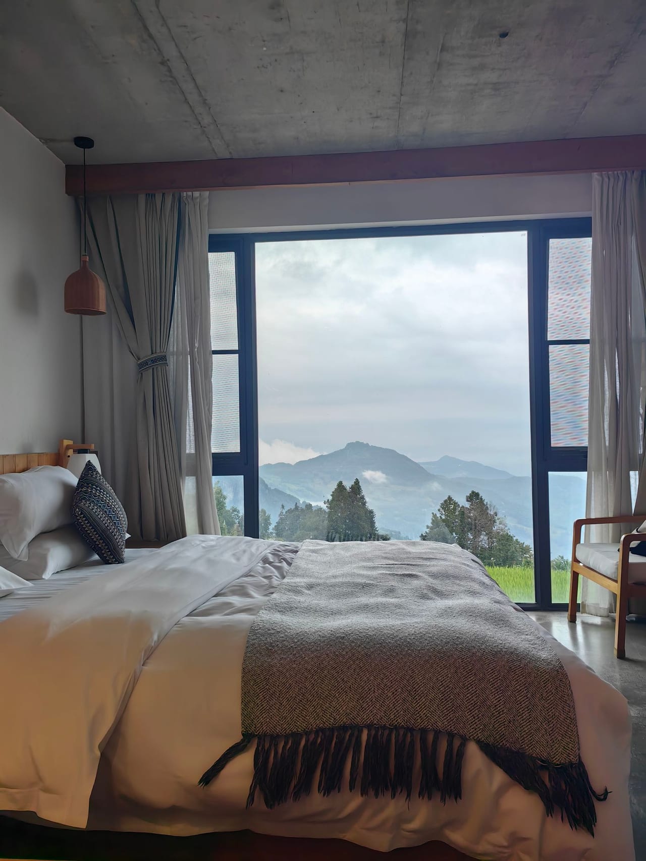 Yuanshe Azheke — bedroom looking out to mist over the valley